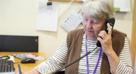 Volunteer using the phone