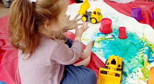 Two children engage in messy play activities