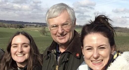 Family photo of Dave and his family in the countryside