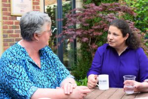 Two members of the compassionate community meeting over a cup of tea.