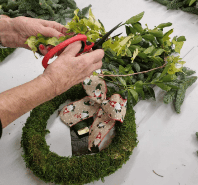 Person making Christmas wreath