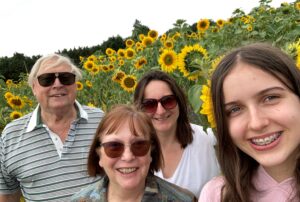 Colin and his family with sunflowers in the background
