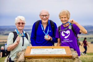 3 walkers celebrating at the end of the 3 Peaks challenge