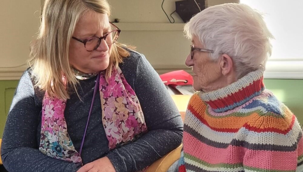 Compassionate cafe volunteer with patient