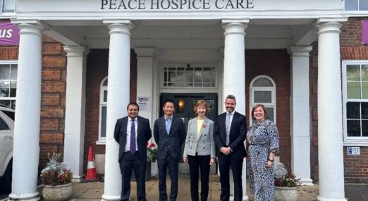 Sarit Shah, Tatsuo Murakami, Debbie Callaghan, Russell Long – all Riso UK – and Lisa Meagher, Corporate Partnerships Manager for Rennie Grove Peace Hospice Care stood outside the Peace Hospice.