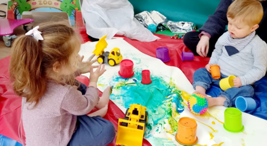 Two children engage in messy play activities for Hospice Care Week 2022