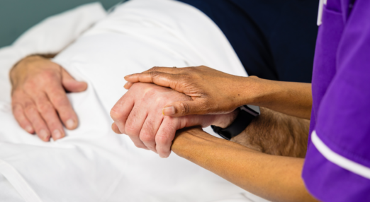 nurse holding hand with patient