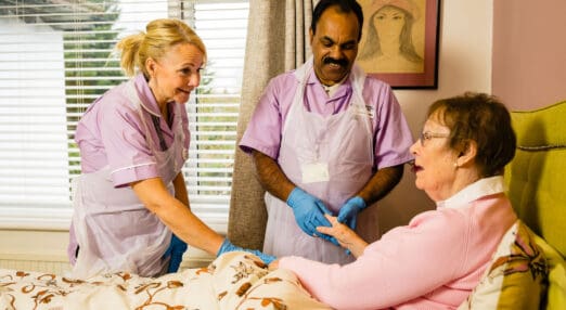 nurses helping patient at her home