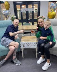 two people holding up glasses in IPU with a child