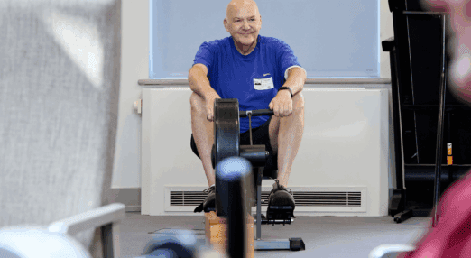 man using rowing machine in outpatient unit