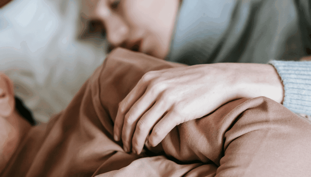 people cuddling in bed