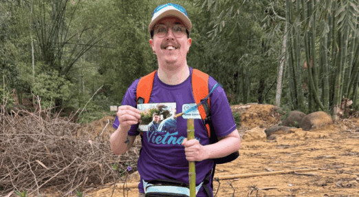man standing holding photo of dad