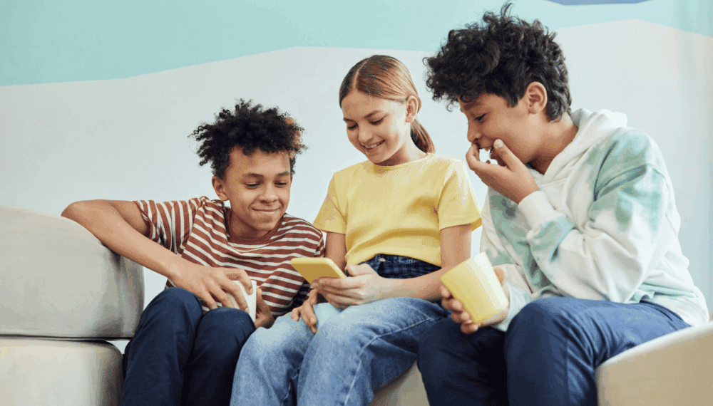 school children looking at a phone