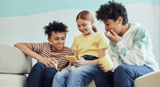 school children looking at a phone