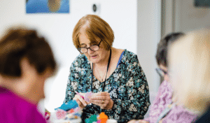 People taking part in an arts and crafts activity at the CompassionART Café at Grove House in St Albans.