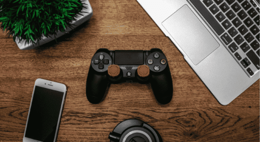 Gaming controller, laptop, smartphone and headphones representing technology, gaming and electronic products for online resale.
